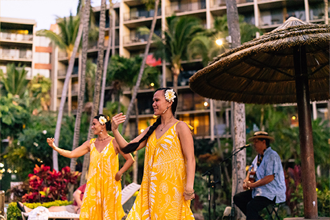 Two hula dancers and musician