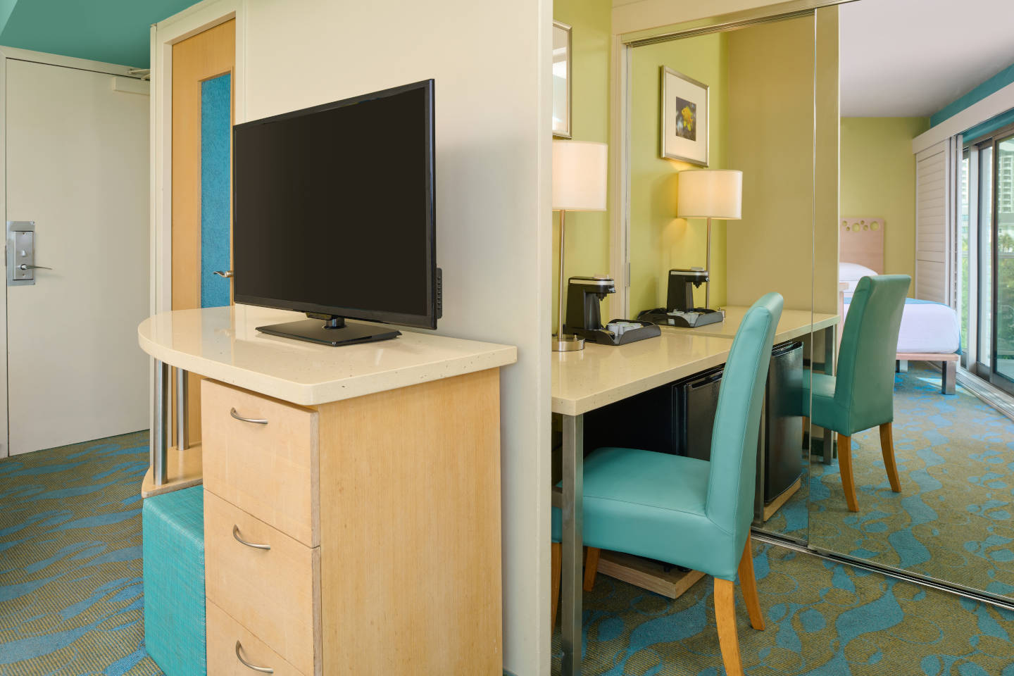 Oceanfront Room amenities include a desk seating area and television