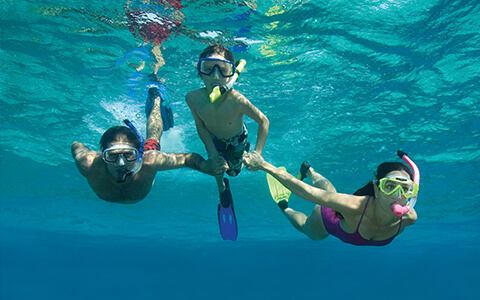 Family of three snorkeling