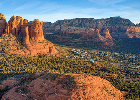 Aerial view of Sedona town surrounded by red rock mountains