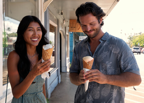 Man and woman eating ice cream cones.