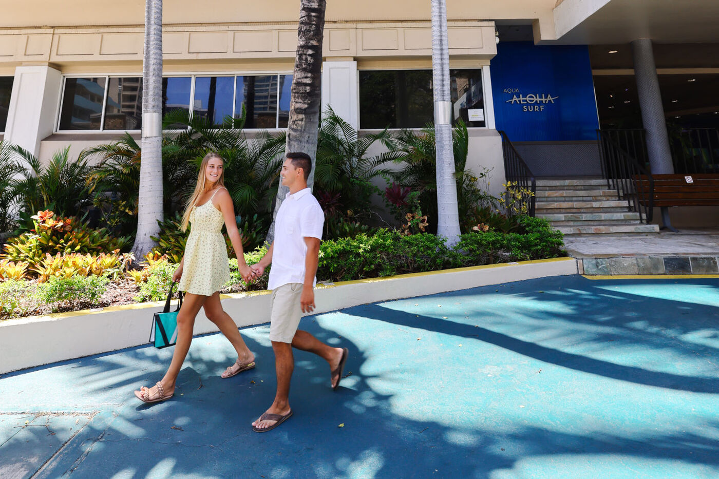 Couple walking near the entrance of the Aqua Aloha Surf