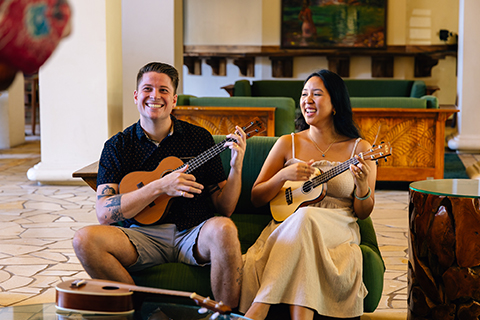Two people playing ukulele
