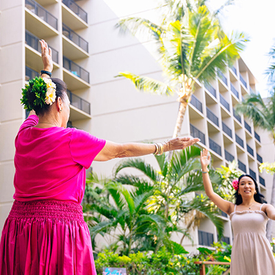 Two women dancing hula