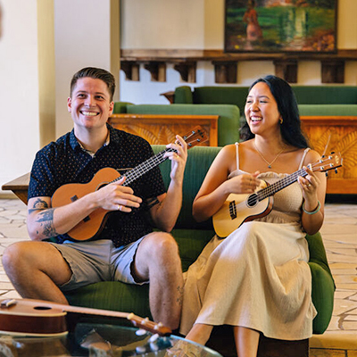 Two people playing the ukulele 