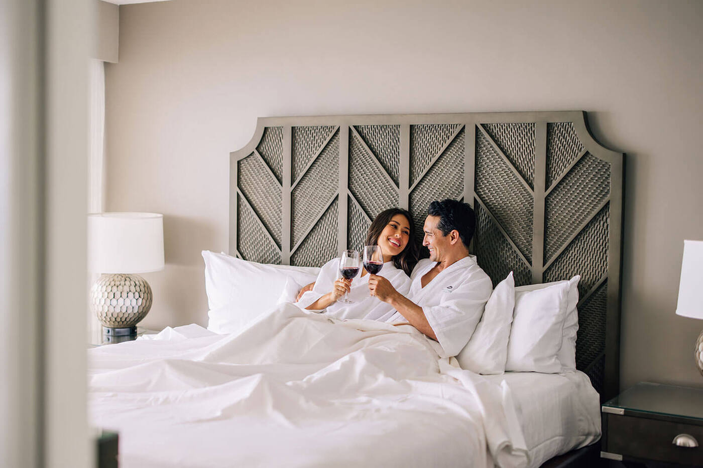 Couple having wine in bed