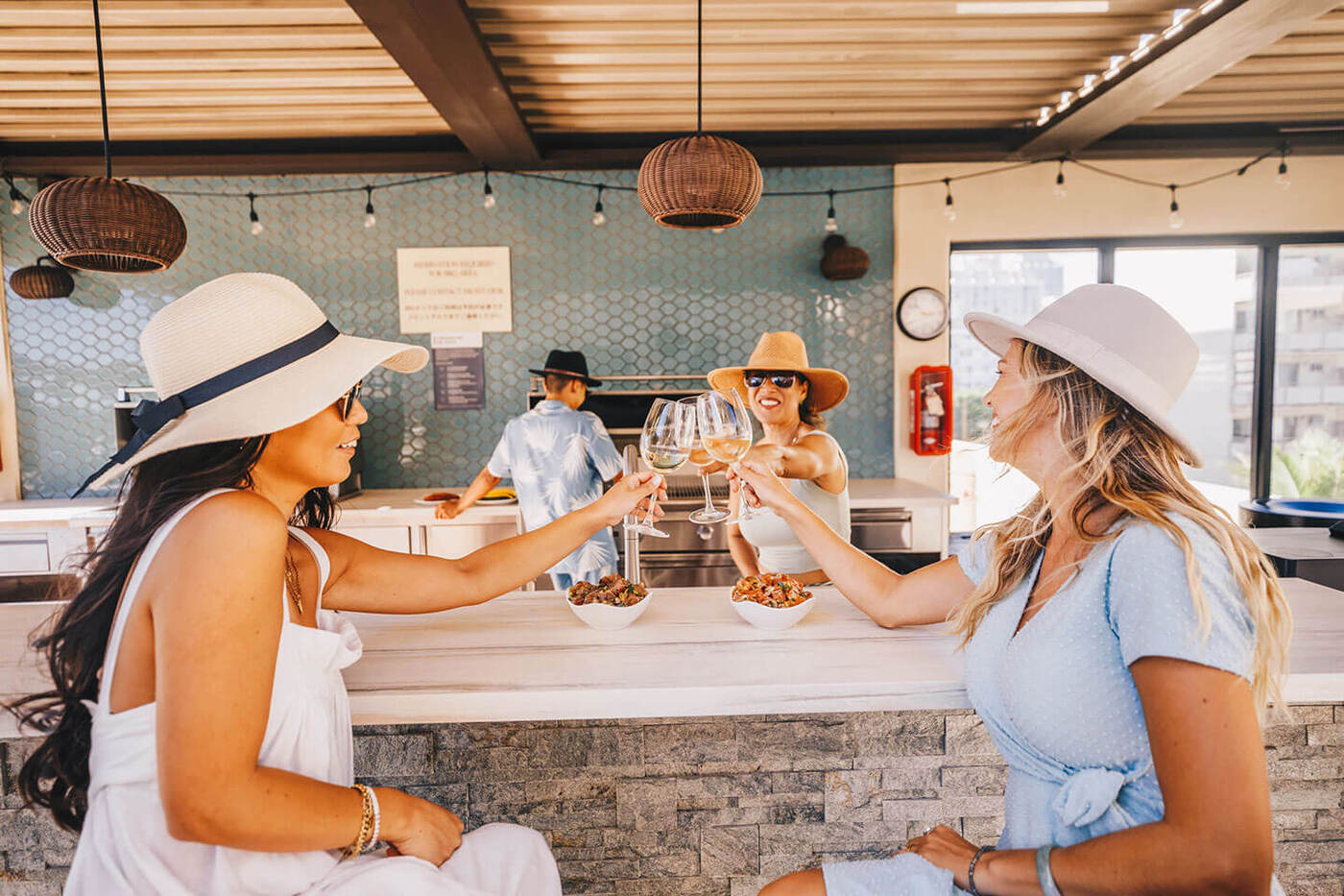 3 women enjoying wine at outdoor dining area