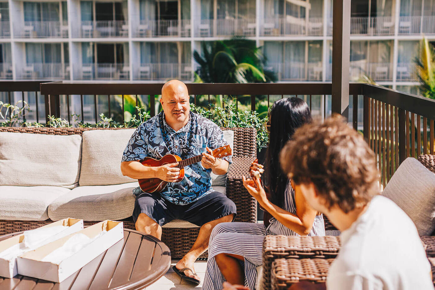 Man showing guests how to use ukulele