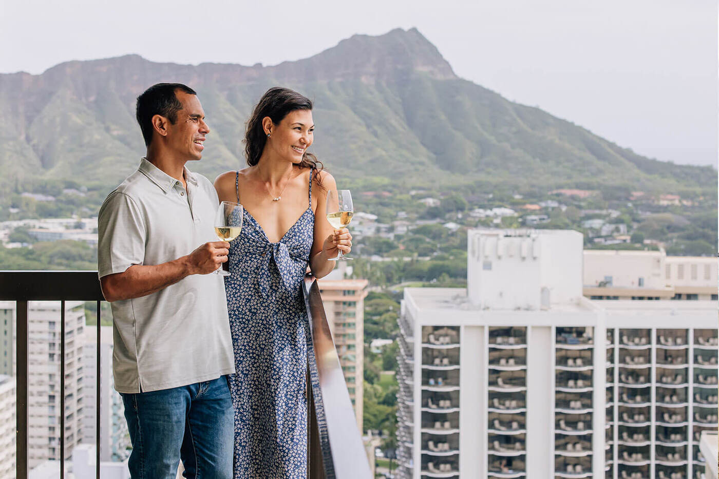 Couple on balcony with Diamond Head in background