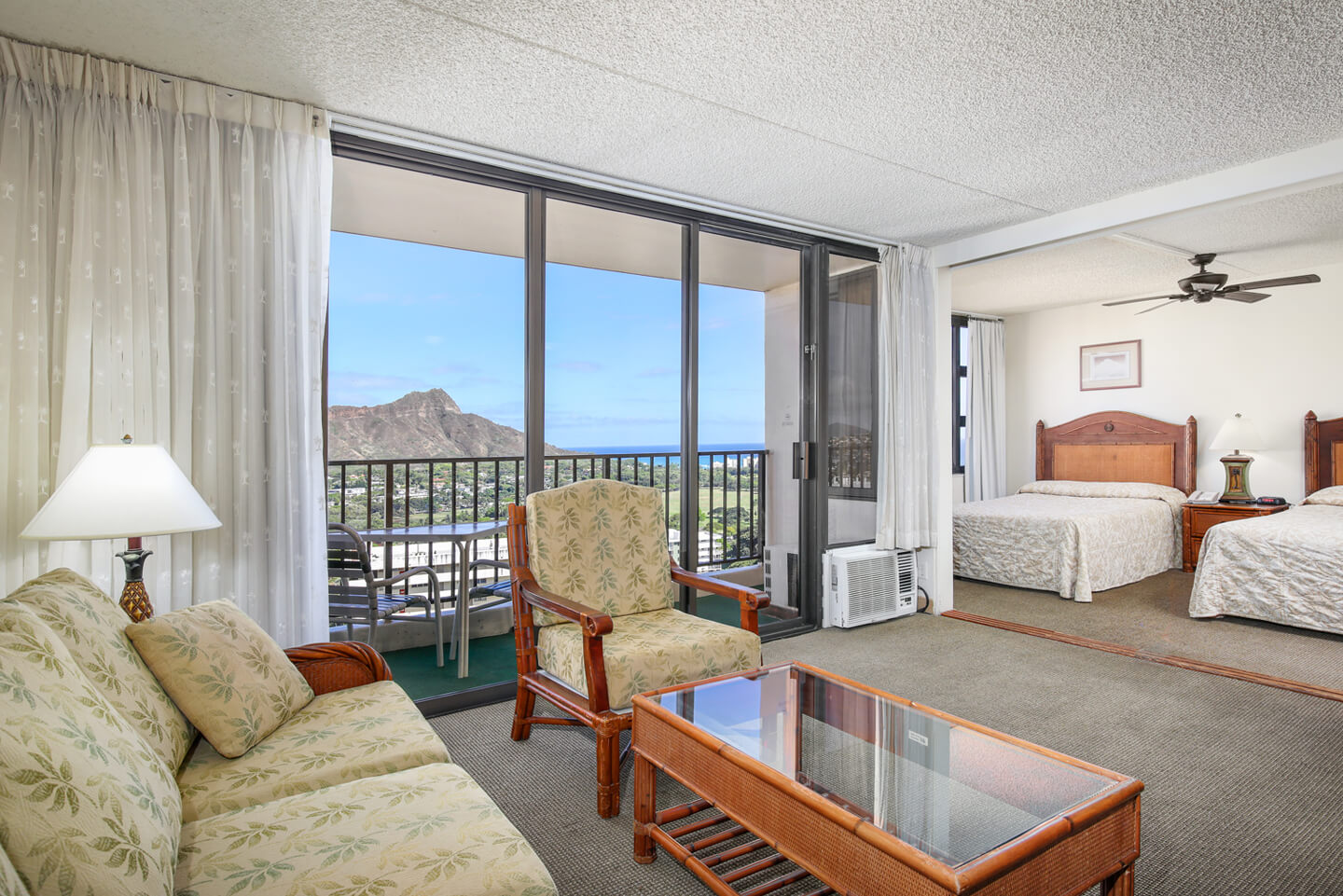 1-Bedroom Deluxe Ocean View living area, separate bedroom, and private balcony.