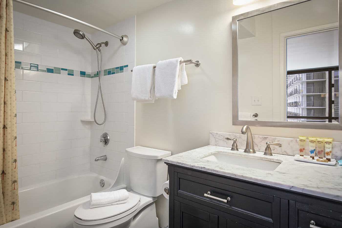 1-Bedroom Standard Suite bathroom with sink, shower/bathtub combo, and toilet.