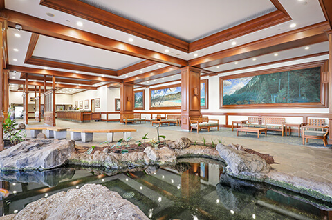 Lobby wh sitting area and koi pond.