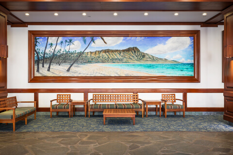 Lobby with large painting and sitting area.