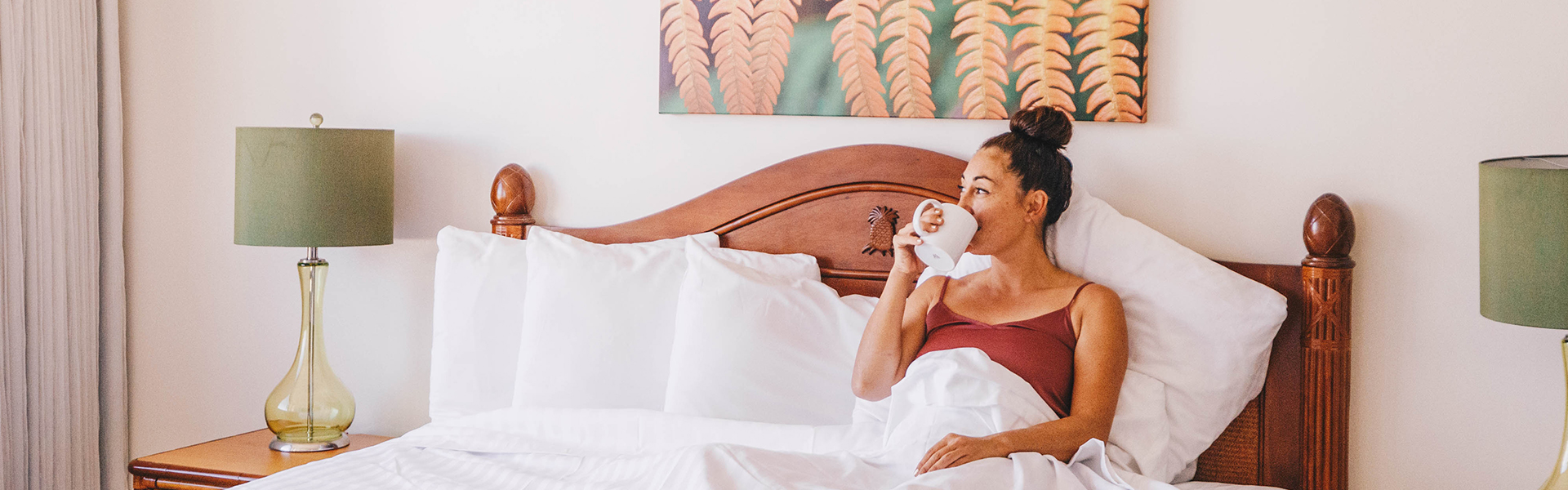 Woman sipping coffe in bed