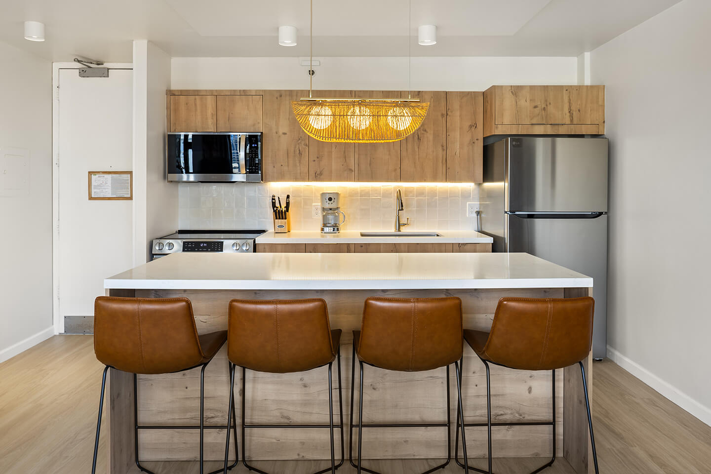 Kitchen with kitchen island and barstools.