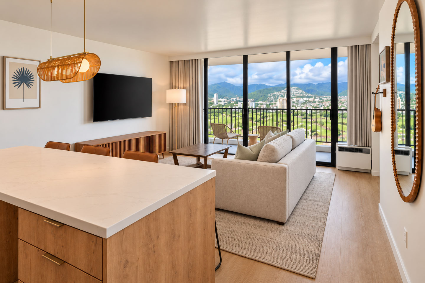 Living room with sofa, sliding door to balcony with view mountains.