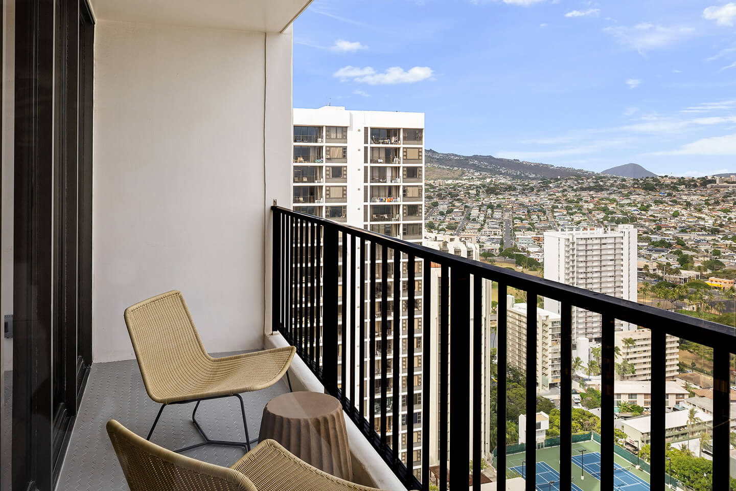 Balcony with chairs and view of mountains.