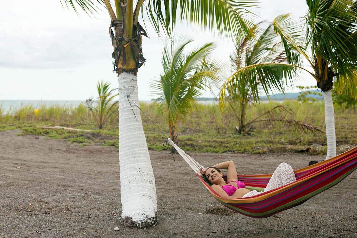 Woman reaxling in hammock on beach