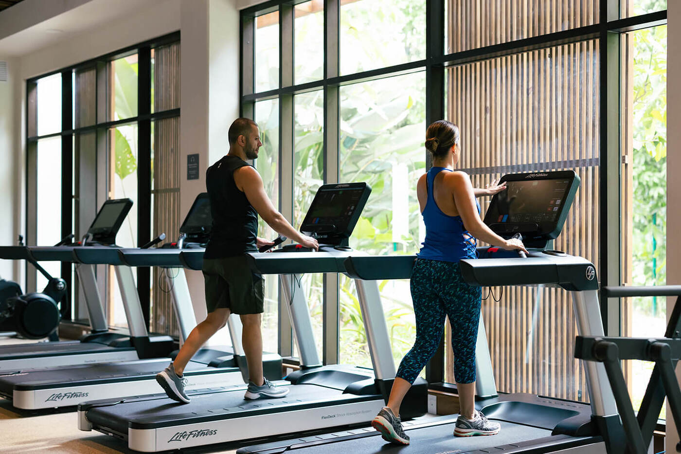 2 people on treadmills in fitness center