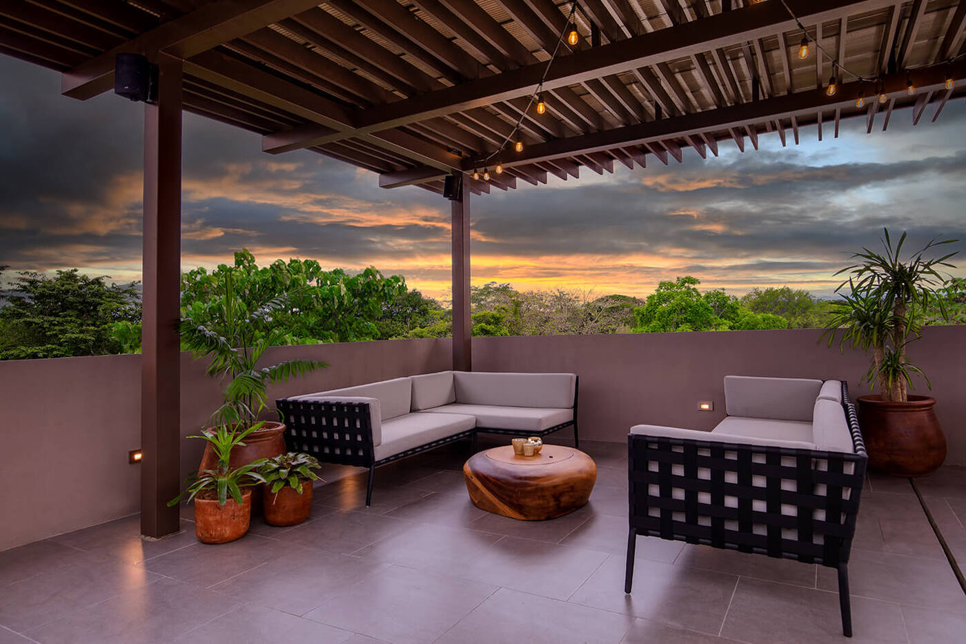 Patio with seating, tbale, views of sunset