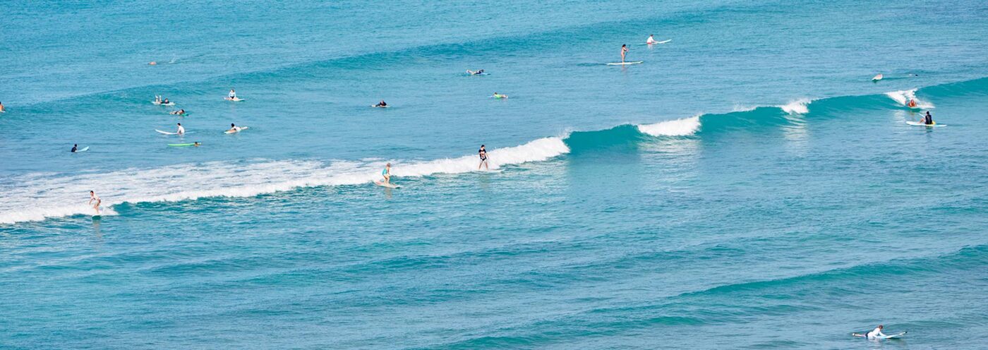 Overhead view of ocean and surfers