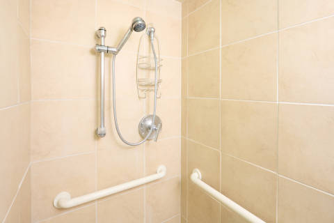Roll-in shower macro with ADA grab bars for accessibility 