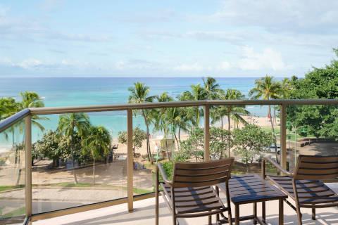 Balcony and seating area and views of Waikiki Beach from the Oceanfront Room at the Aston Waikiki Circle Hotel