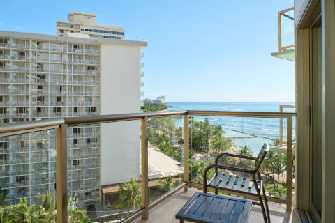 Balcony and seating area from the partial ocean view room enjoying the views of Waikiki from above 