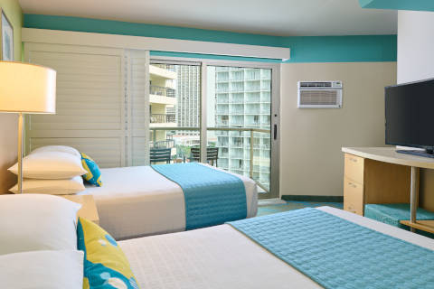 Partial Ocean View Room with plantation shutters and a balcony at the Aston Waikiki Circle Hotel