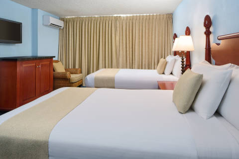 Moderate hotel room with two beds and roll-in shower