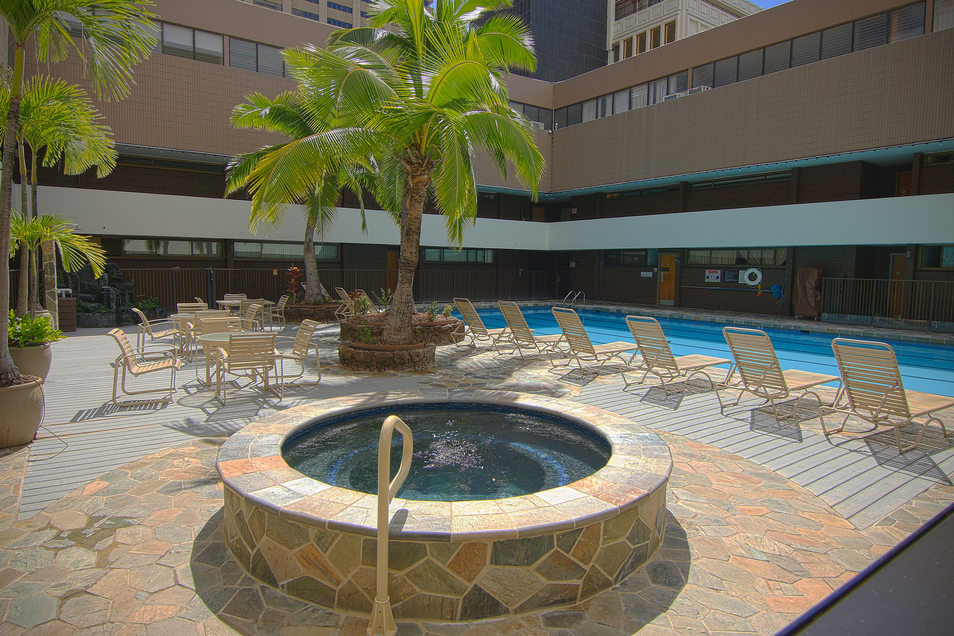 Recreation deck with pool, seating and a hot tub.