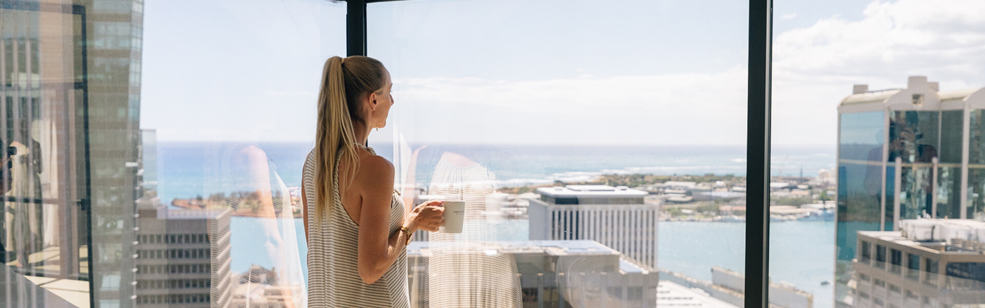 WOman looking at city from window