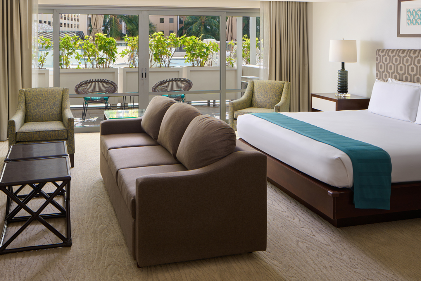 Room with bedding and couch with a view