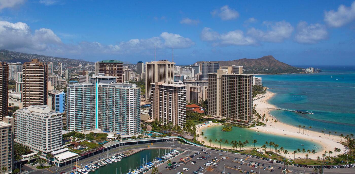 Aerial view of hotel exterior, surrounding area, beach, and Diamond Head in distance