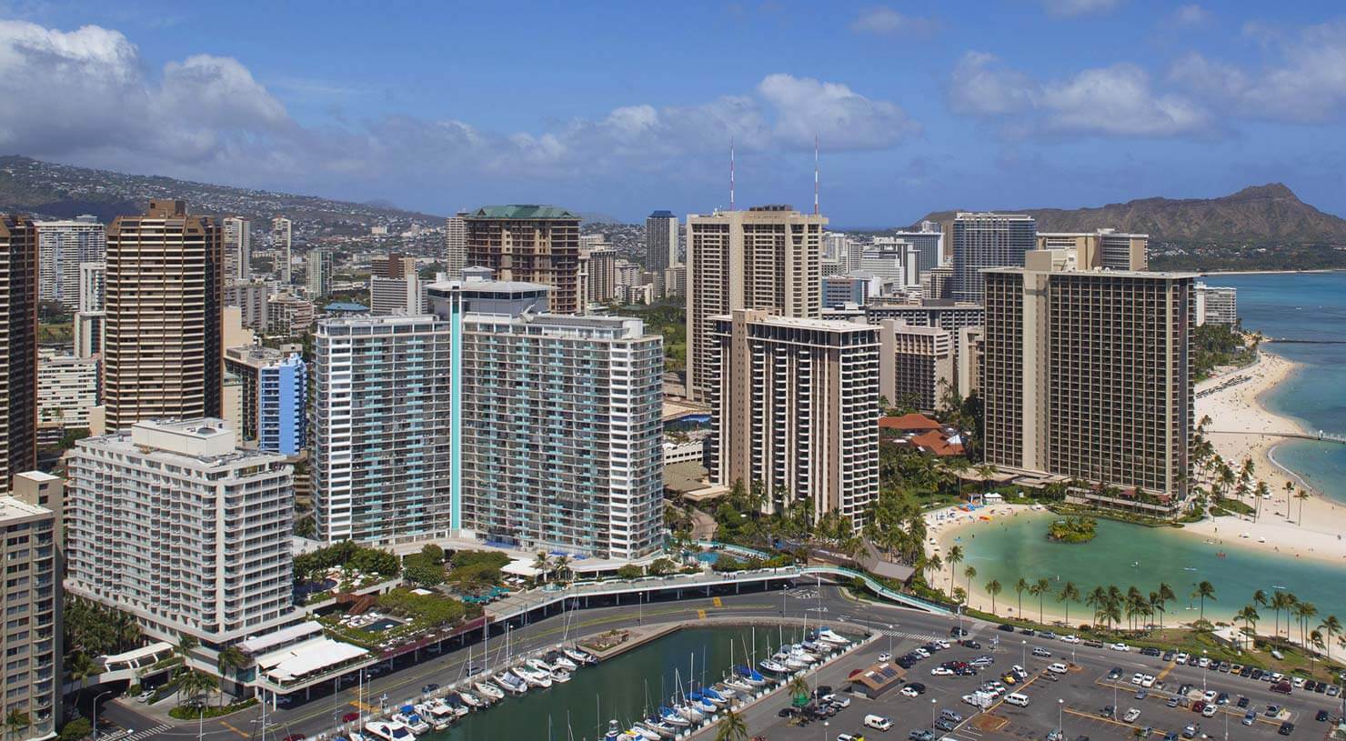 Aerial view of hotel exterior, surroungin area, beachfront, and Diamond Head in distance