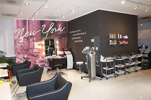 View of salon with chairs and hair tools