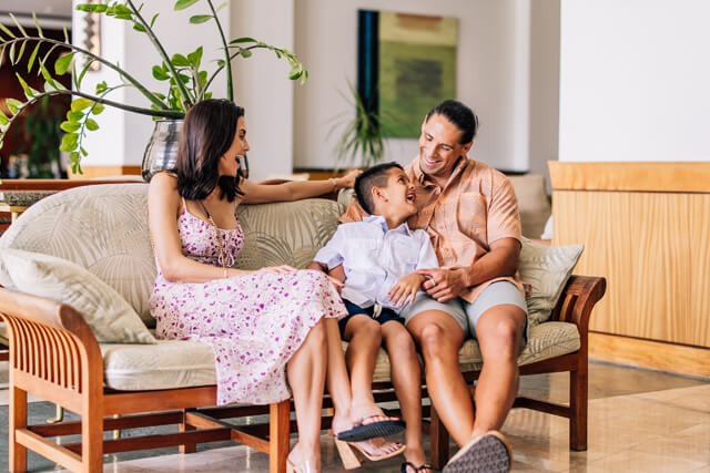 Family sitting in Ilikai's lobby