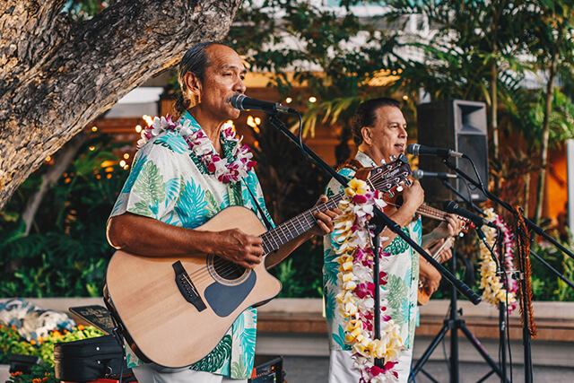 Musicians performing on open-air deck.