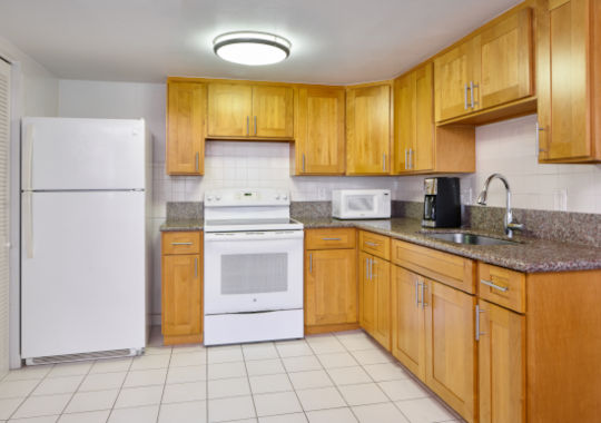 Full kitchen with full sized refrigerator, stove and lots of counter space