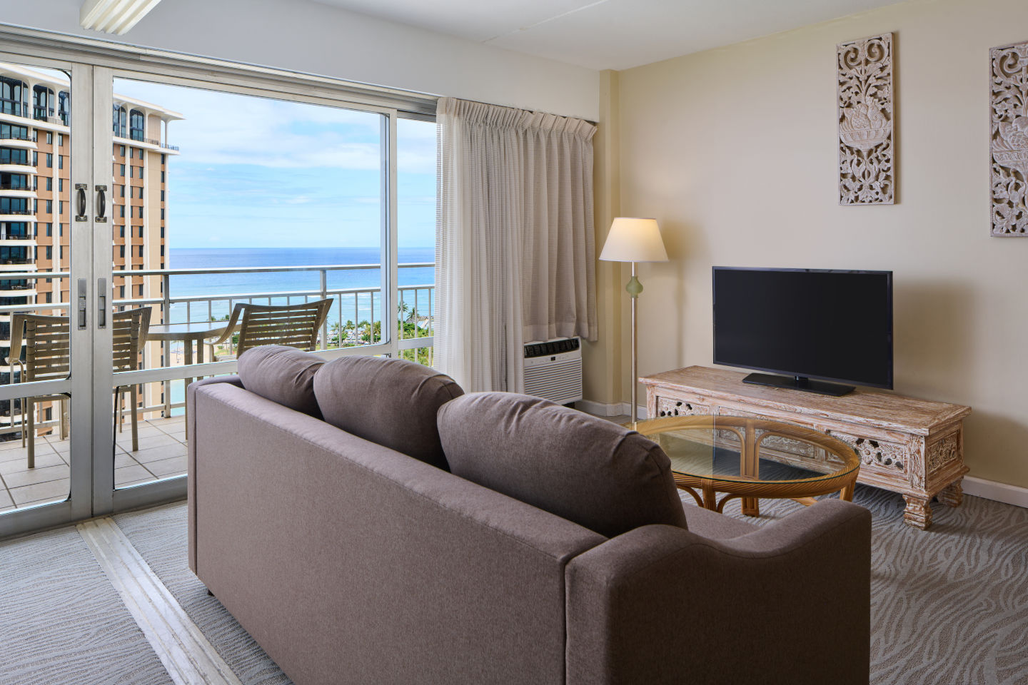 Ilikai Lite Ocean View Suite with Full Kitchen living area with a private balcony and seating area