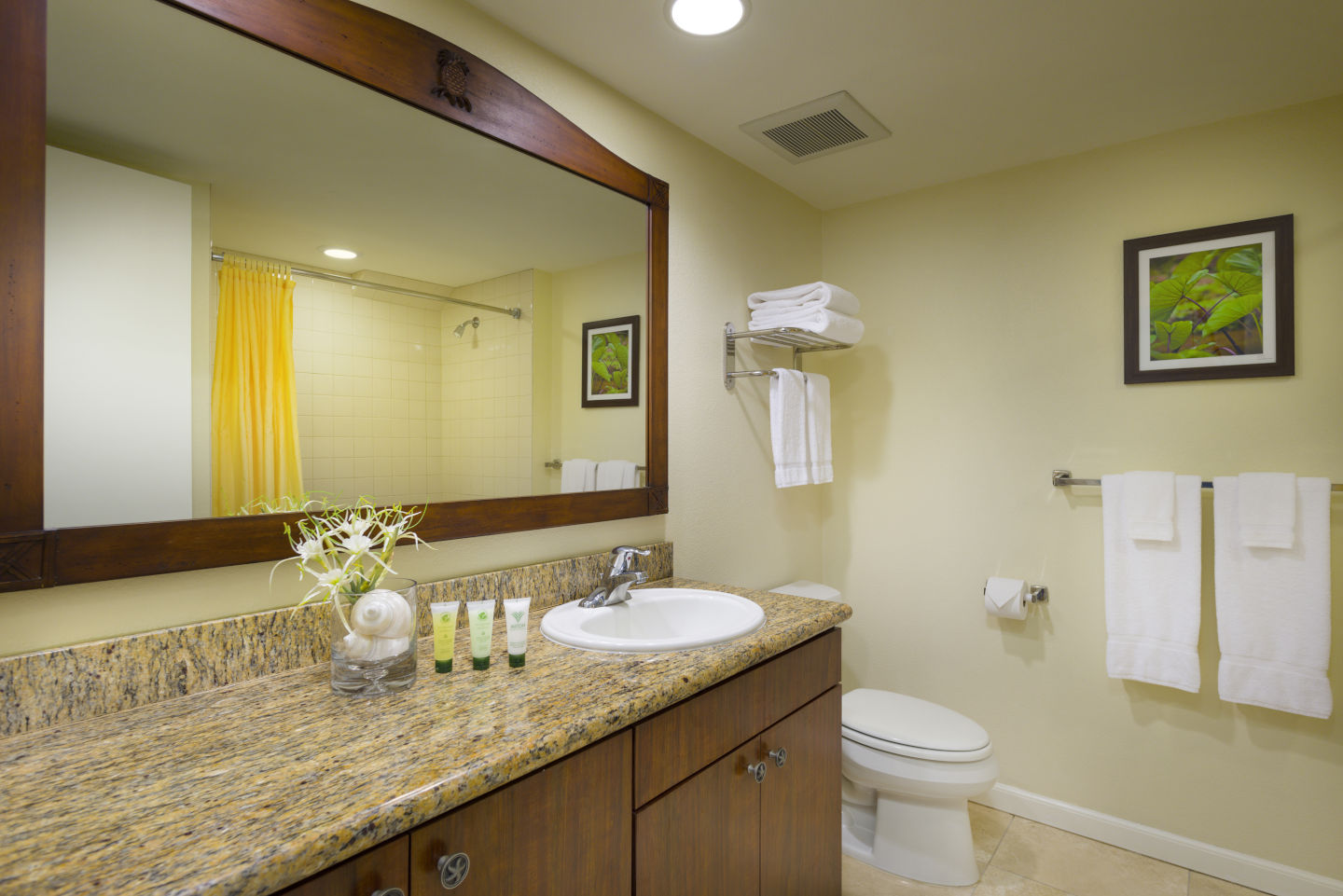 Bathroom with a large mirror and marble countertop in the Aston Islander on the Beach 