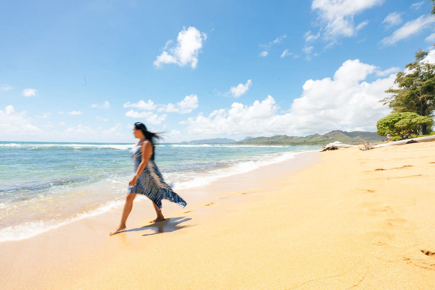 Woman walking on sandy bechfront