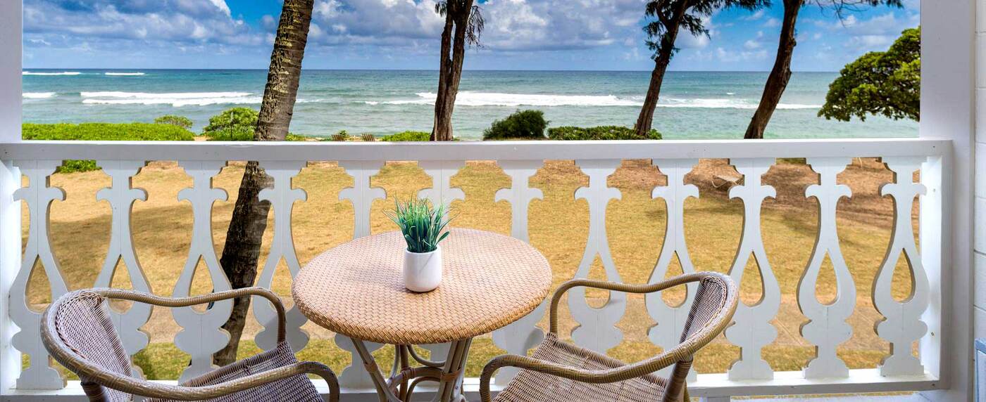 Oceanfront view from patio with chairs and table