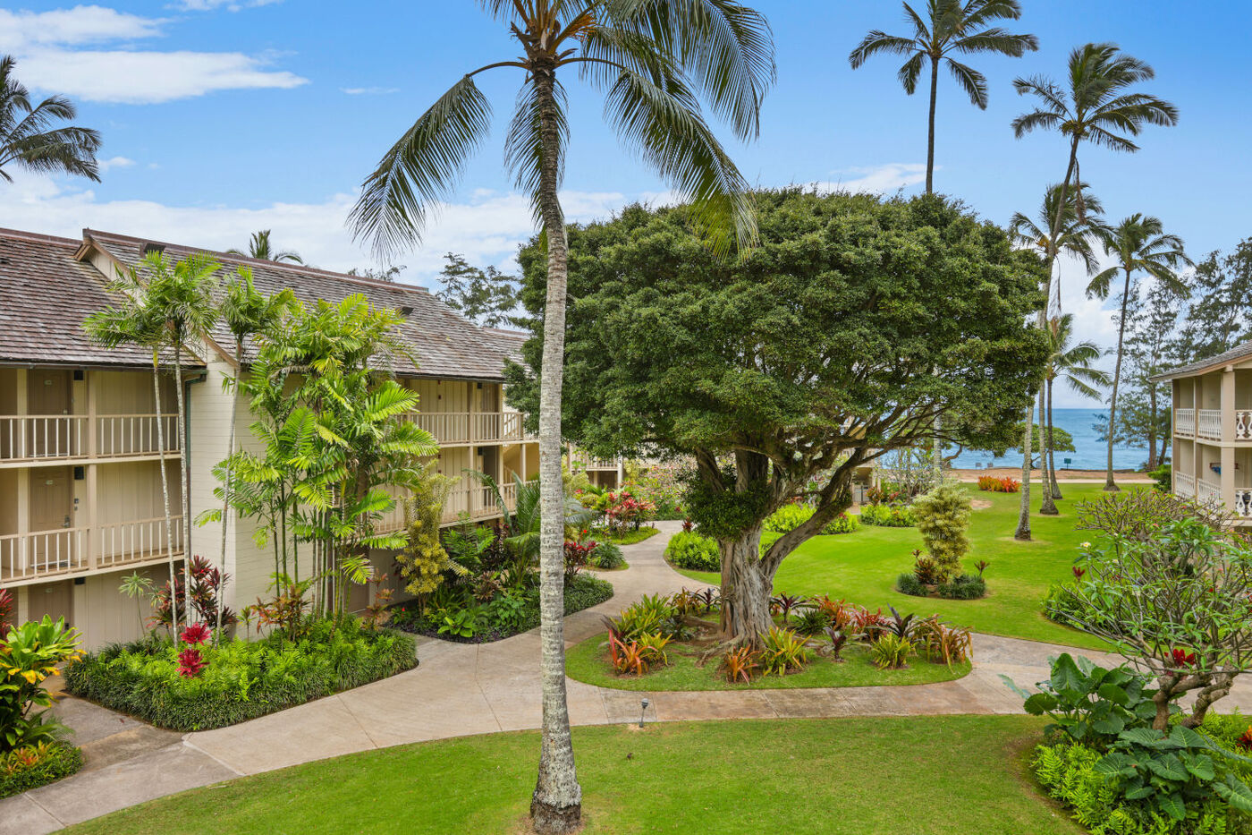 Aston Islander on the Beach lush grounds is landscaped with tropical palm trees, plants and the beach with is just a few steps away