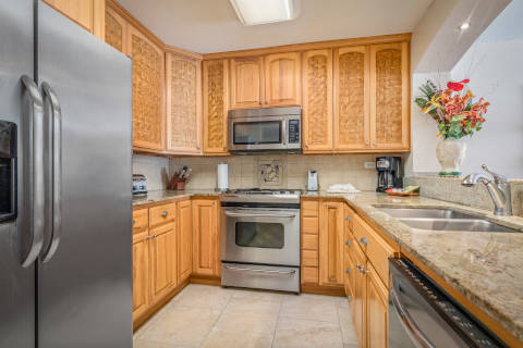 Two-Bedroom Ocean View full size kitchen with stainless steel oven and matching refrigerator