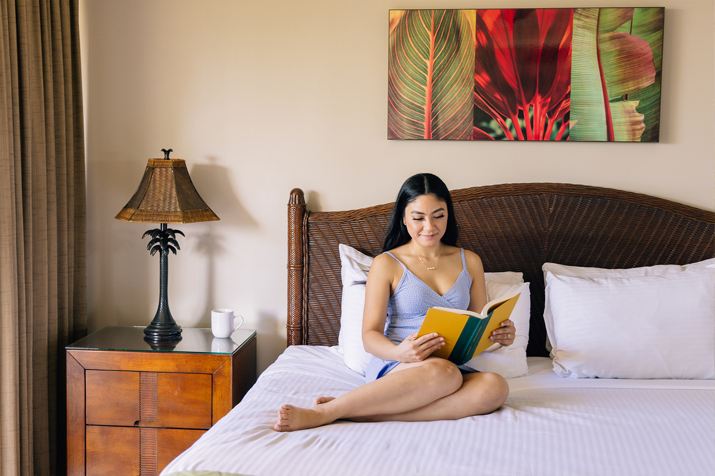 Woman on bed reading book 