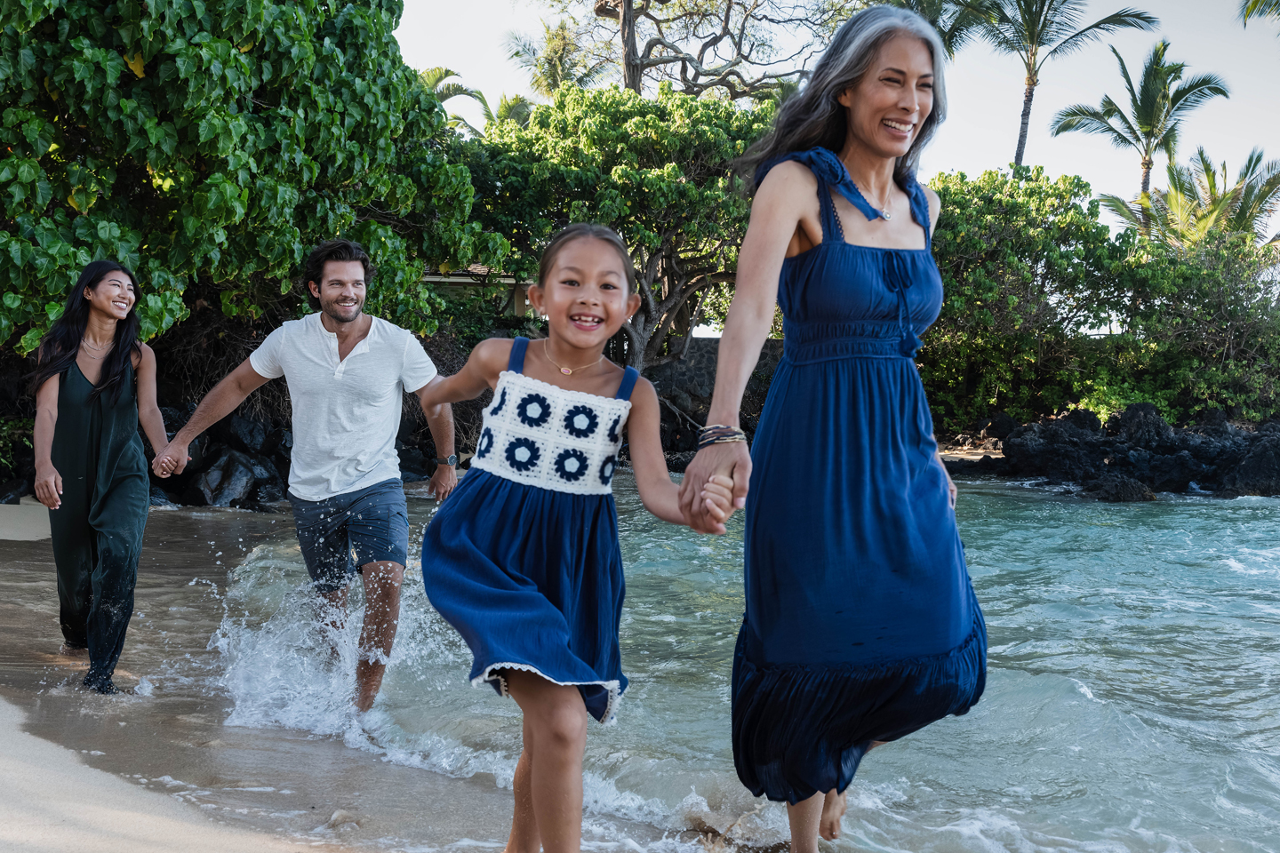 Family enjoying a walk along the beach.
