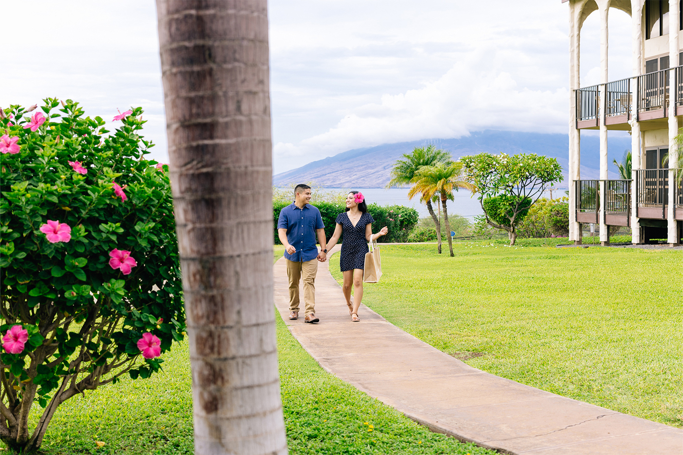 couple walking along path on resort grounds