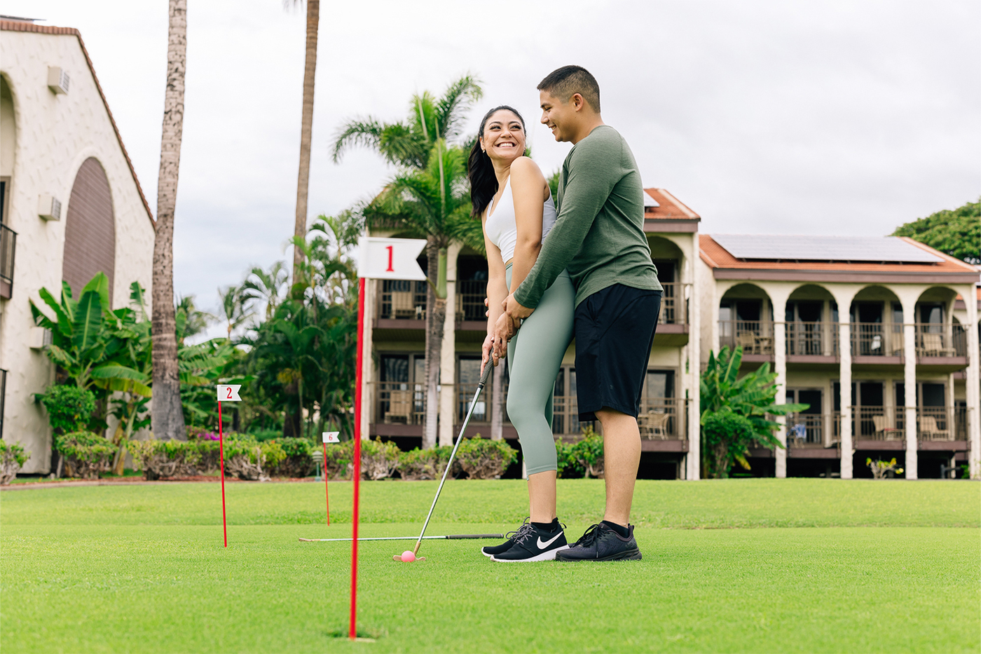 Couple playing on putting green