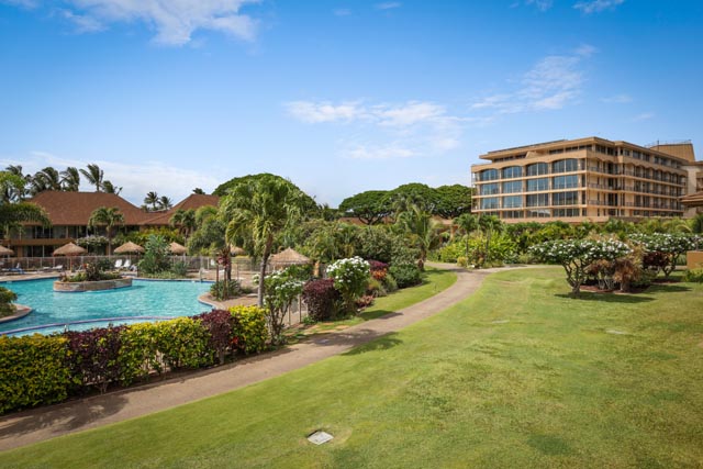 view of the resort with the pool and lawn 